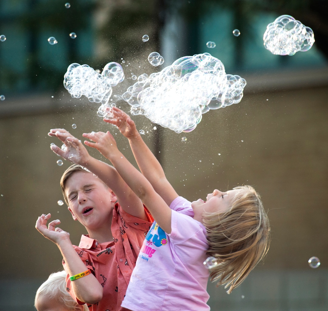 (Rick Egan  |  The Salt Lake Tribune)      Kids chase bubbles as they fall from the bubble tower at the Utah State Fair, Thursday, Sept. 6, 2018.