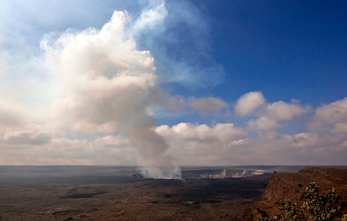 FILE - This Sept. 1, 2015 file photo shows volcanic gas rising from the lava lake in Kilauea's Halemaumau Crater in Hawaii Volcanoes National Park on Hawaii's Big Island. Hawaii residents and an organization representing federal workers filed a lawsuit against the Federal Aviation Administration on Wednesday, Oct. 4, 2017 seeking to force it to do something about tour helicopters buzzing their communities and national parks across the country. (AP Photo/Caleb Jones, File)