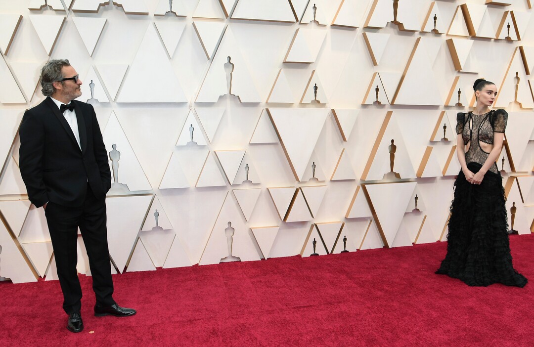 (Richard Shotwell | Invision/AP)  Joaquin Phoenix, left, and Rooney Mara arrive at the Oscars on Sunday, Feb. 9, 2020, at the Dolby Theatre in Los Angeles.