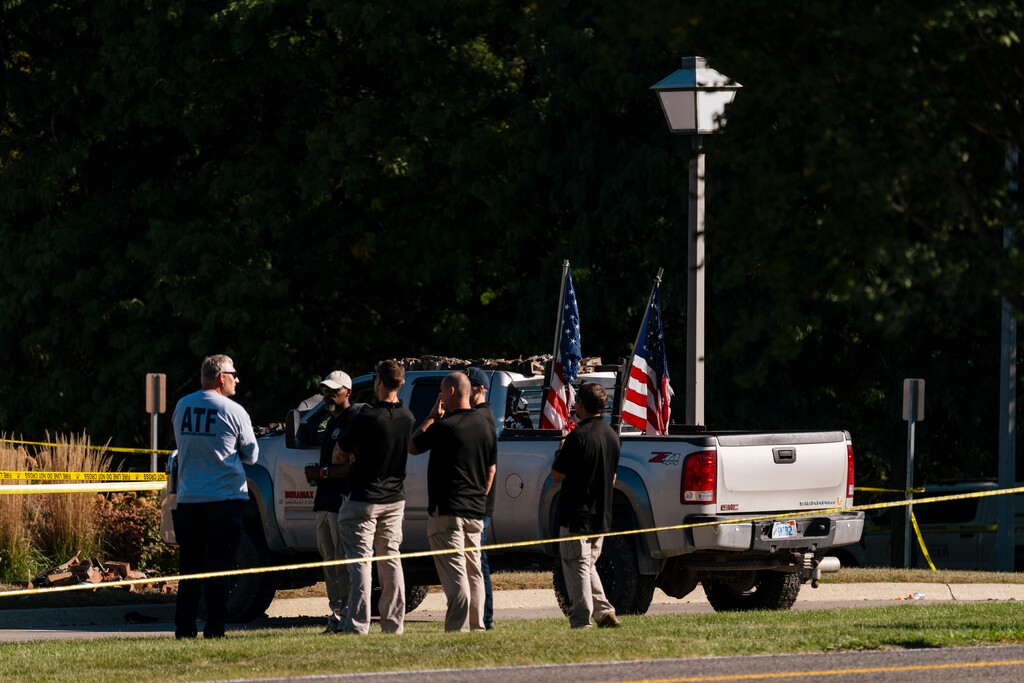 (Nick Hagen | The New York Times) Investigators with the truck driven by the gunman in the attack on a meetinghouse of The Church of Jesus Christ of Latter-Day Saints in Grand Blanc Township, Mich., on Monday, Sept. 29, 2025. At least four people were killed after a gunman attacked the church on Sunday, the authorities said.