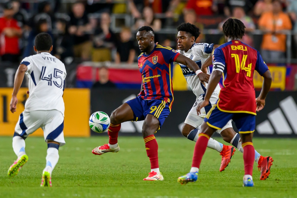Real Salt Lake striker William Agada (9) gains possession of the ball defended by Vancouver Whitecaps defender Sam Adekugbe (3) during an MLS soccer match, Saturday, May 24, 2025, in Sandy, Utah. On Saturday, July 12, 2025, Agada scored for RSL in a 1-0 win over the Houston Dynamo. (AP Photo/Tyler Tate)