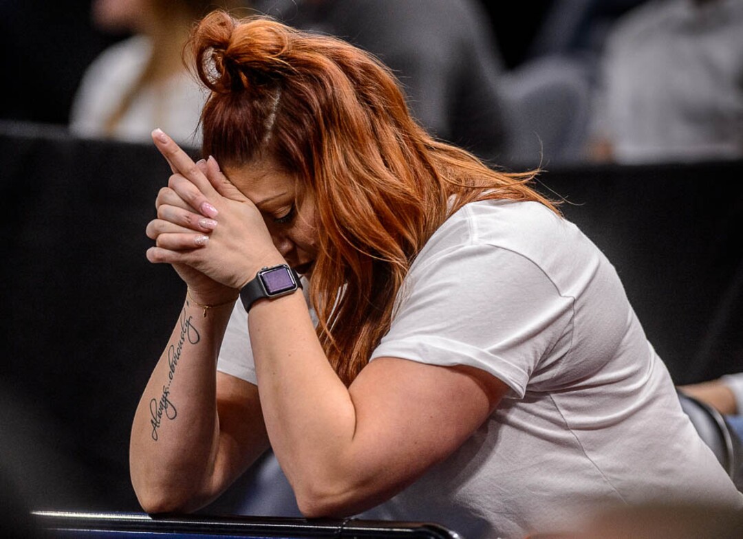 (Trent Nelson | The Salt Lake Tribune)  An Auburn fan bows her head during a free throw as Auburn faces New Mexico State in the 2019 NCAA Tournament in Salt Lake City on Thursday March 21, 2019.
