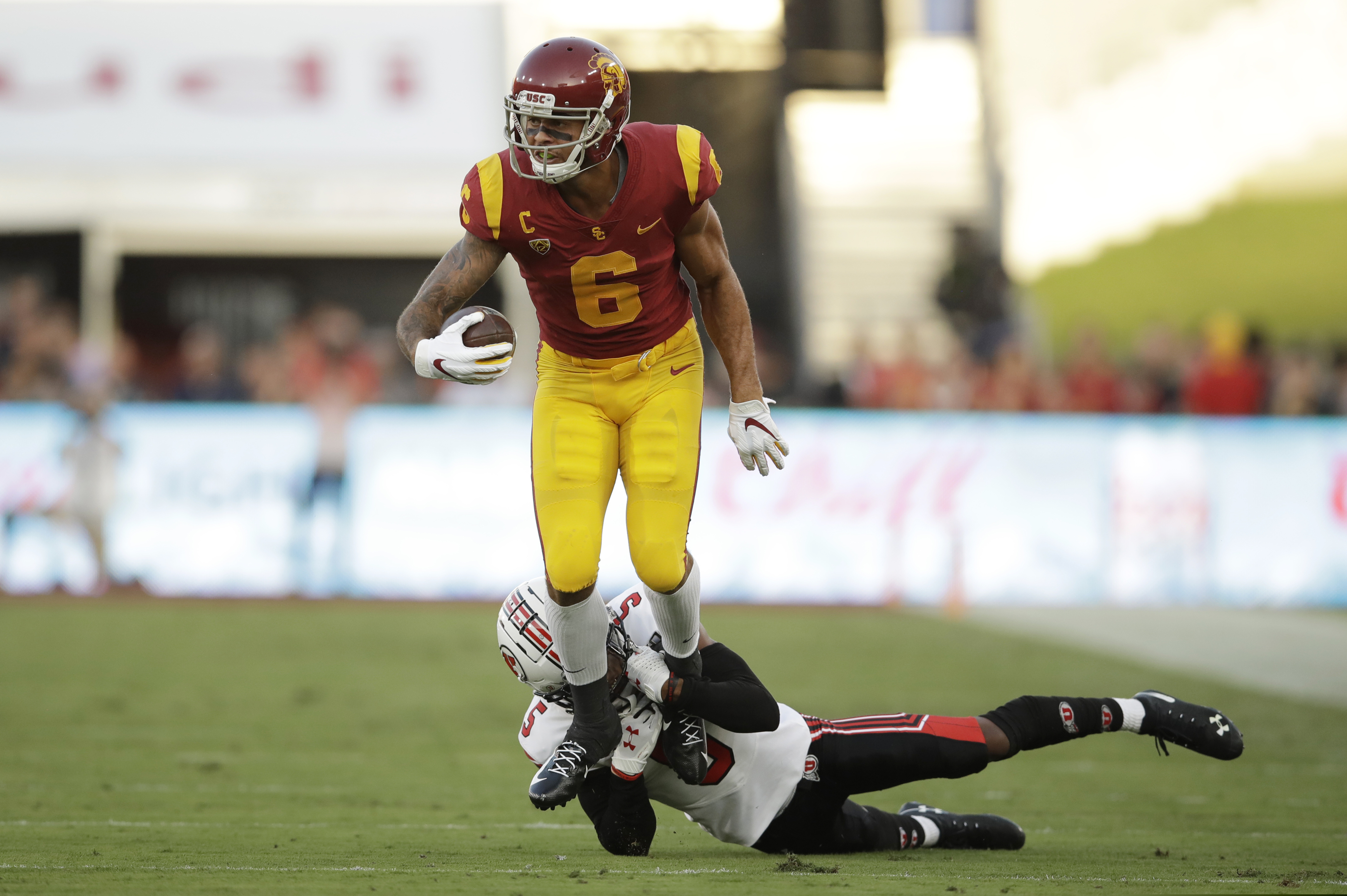 (AP Photo/Marcio Jose Sanchez) Southern California wide receiver Michael Pittman Jr. (6) is tackled by Utah defensive back Tareke Lewis during the first half of an NCAA college football game Friday, Sept. 20, 2019, in Los Angeles.