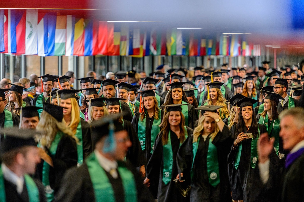 Trent Nelson  |  The Salt Lake Tribune
Utah Valley University graduates walk through the school's Hall of Flags at the beginning of commencement in Orem, Thursday, April 28, 2016. UVU awarded 5,409 degrees at its 75th commencement.