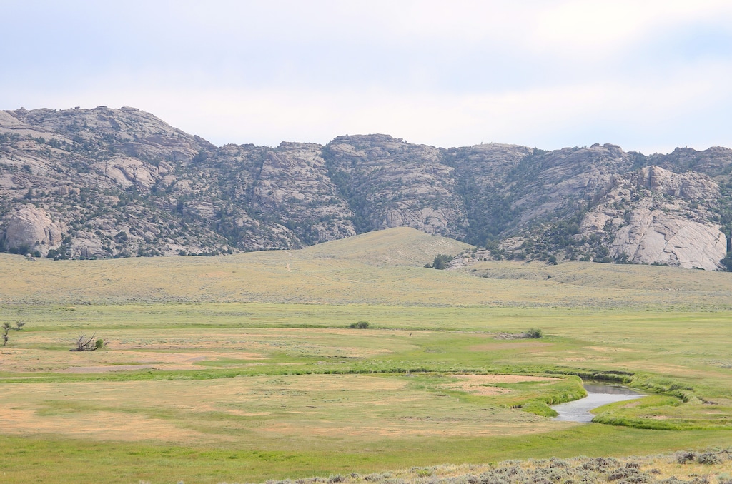 (Mike Koshmrl | WyoFile) Debate remains about where the Martin Company's roughly 500 Mormon emigrants took shelter during an October 1856 blizzard. Elders with The Church of Jesus Christ of Latter-day Saints in the 1930s christened this nook of the Granite Mountains as "Martin's Cove."