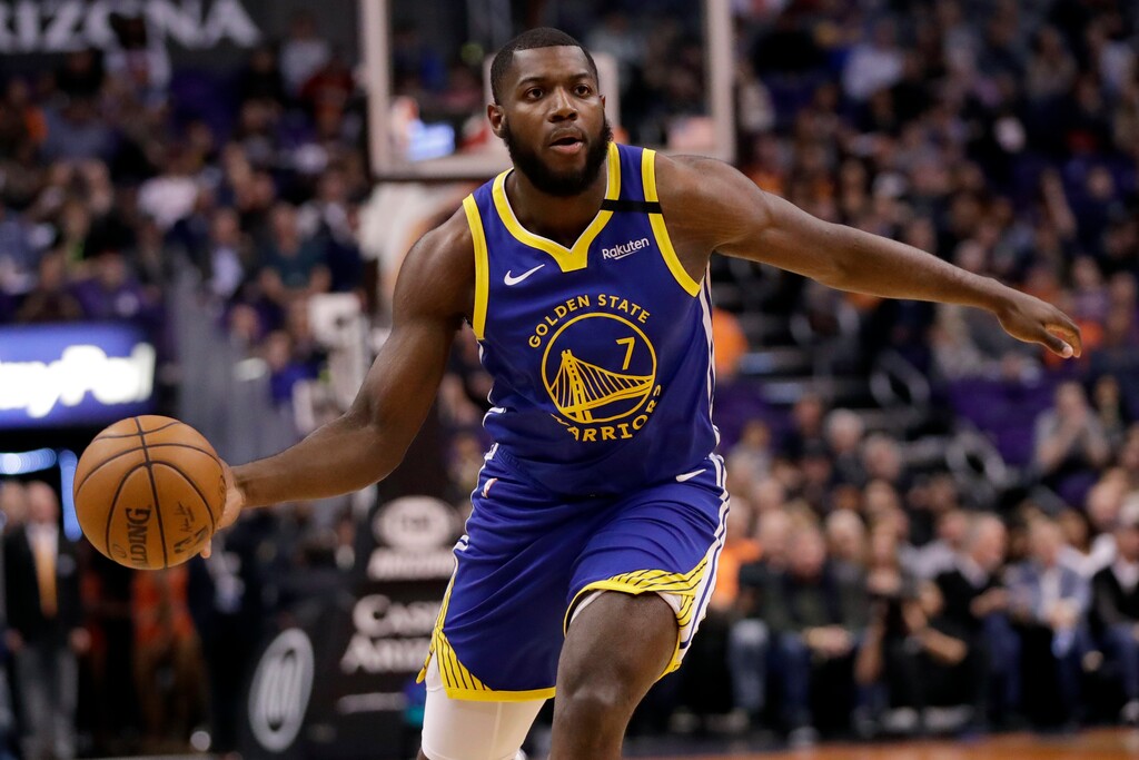 Golden State Warriors forward Eric Paschall (7) looks to pass against the Phoenix Suns during the first half of an NBA basketball game, Wednesday, Feb. 12, 2020, in Phoenix. (AP Photo/Matt York)