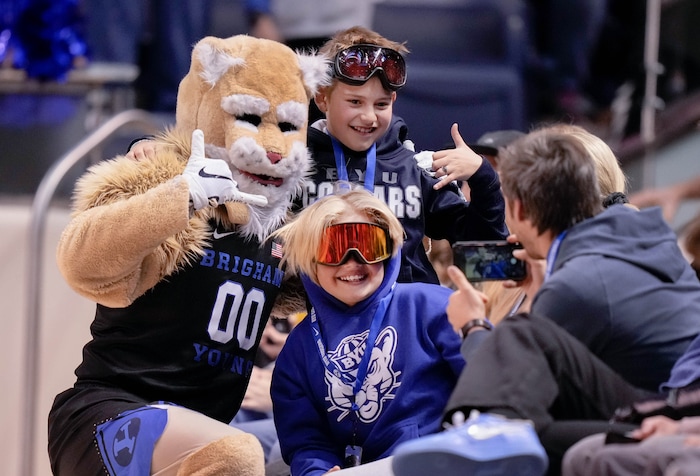 (Francisco Kjolseth | The Salt Lake Tribune) Cosmo poses for a fan picture as the Brigham Young Cougars face off with the Westminster Griffins at the Marriott Center in Provo, Wednesday, Dec. 29, 2021.