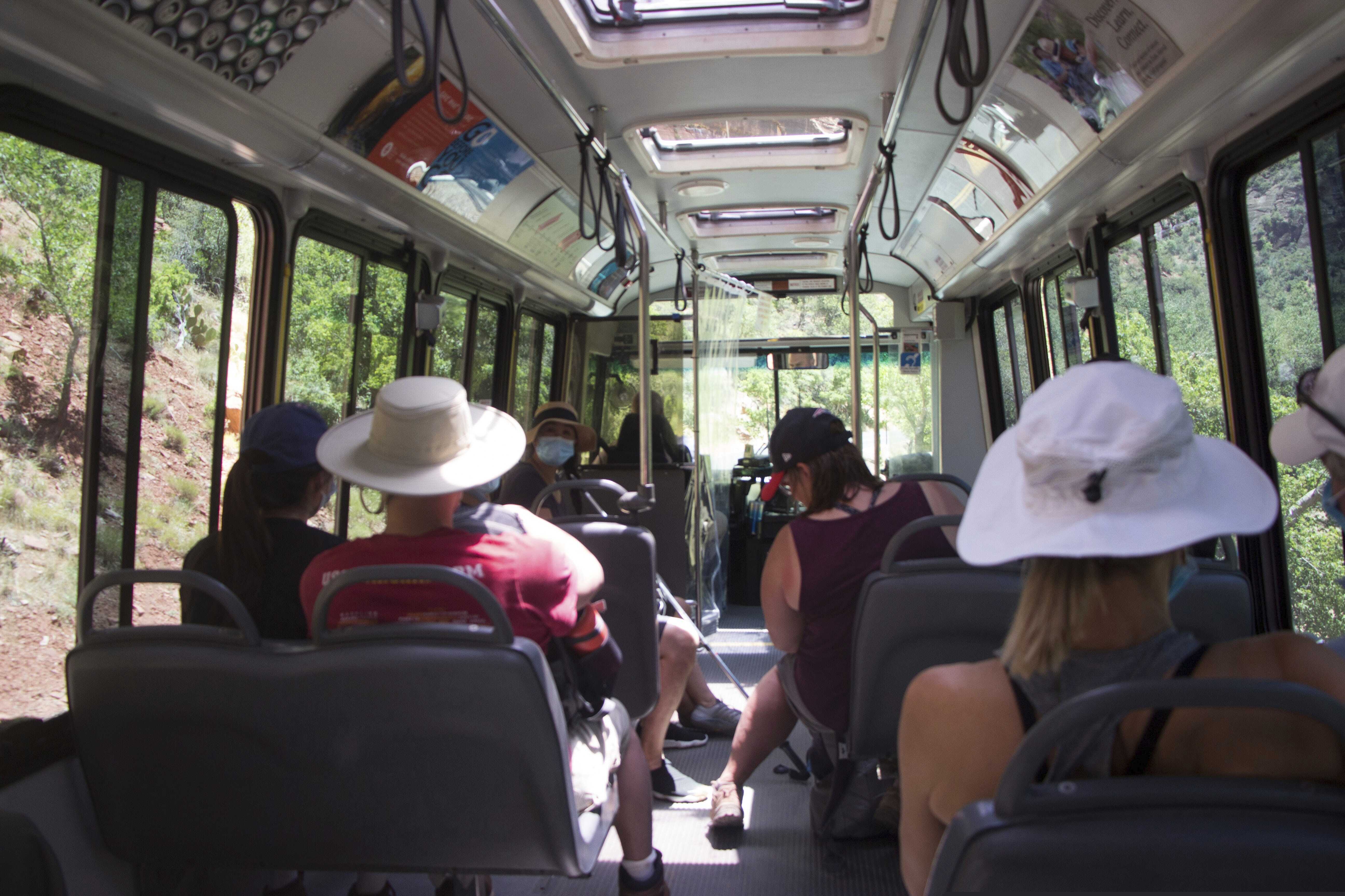 (K. Sophie Will | The Spectrum via AP) Visitors to Zion National Park, Utah ride a shuttle bus on Wednesday, July 1, 2020. Now two decades old, the buses are falling apart but there is no money to replace them.