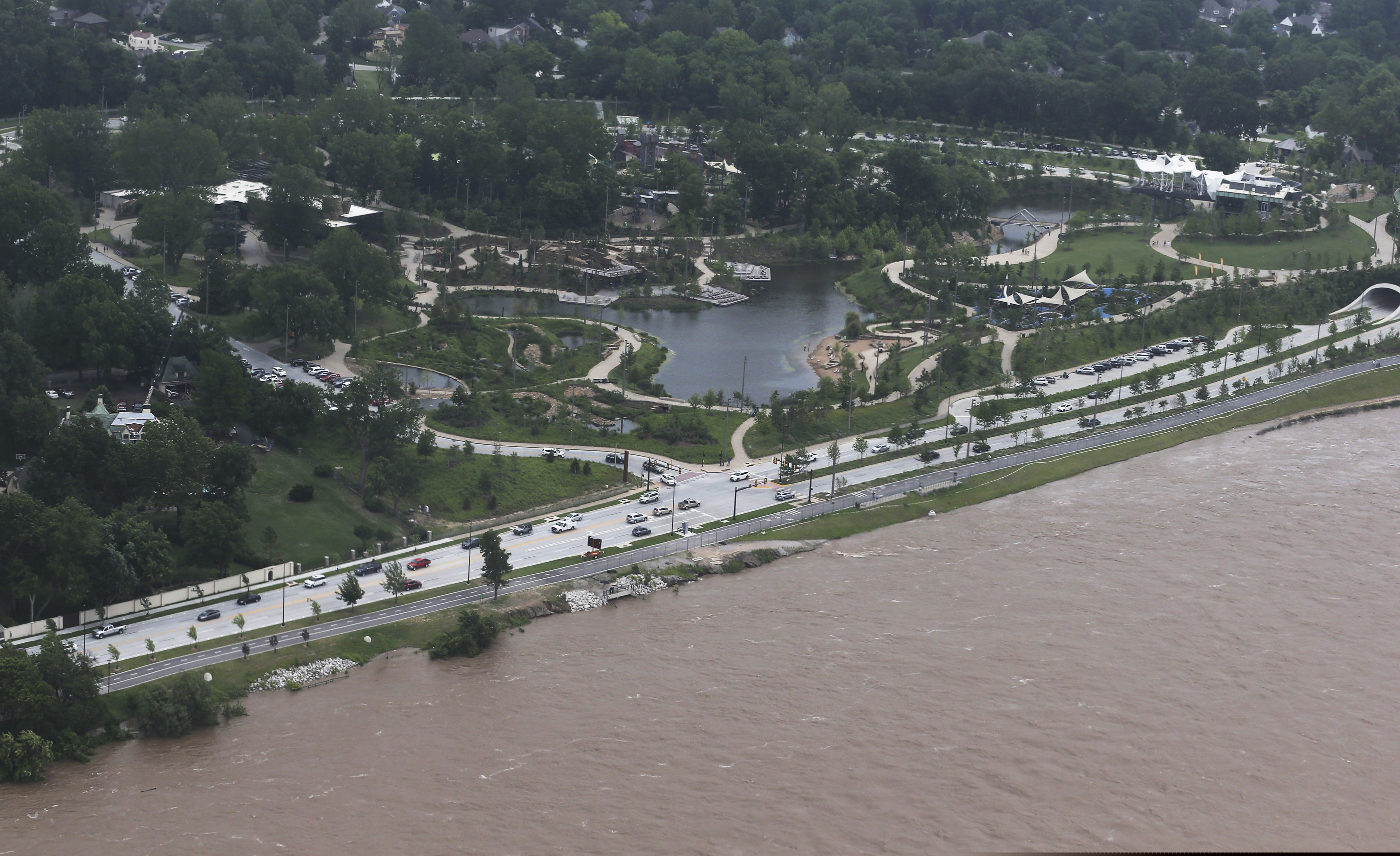 (Tom Gilbert/Tulsa World via AP) The Gathering Place near the Arkansas river on Wednesday, May 22, 2019. Authorities on Wednesday encouraged people living along the Arkansas River in the Tulsa suburb of Bixby and low-lying areas near creeks both north and south of Okmulgee, about 35 miles (56 kilometers) south of Tulsa. to leave their homes.