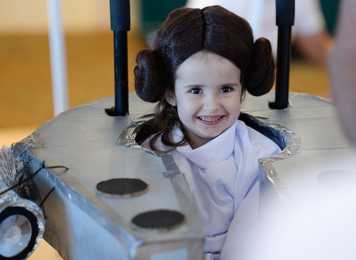(Francisco Kjolseth  |  The Salt Lake Tribune)  Annika Ellefsen, 4, is all smiles as Princess Leia in her Millennium Falcon as volunteers and staff at Shriners Hospital for Children in Salt Lake transform the wheelchairs of 28 patients for Halloween, Wednesday, Oct. 17, 2018. Annika, who has spina bifida, loves her visits to Shriners, according to her mother, Jennifer. Last year her wheelchair was transformed into a princess carriage and "she beamed all night long," exclaimed her mother.