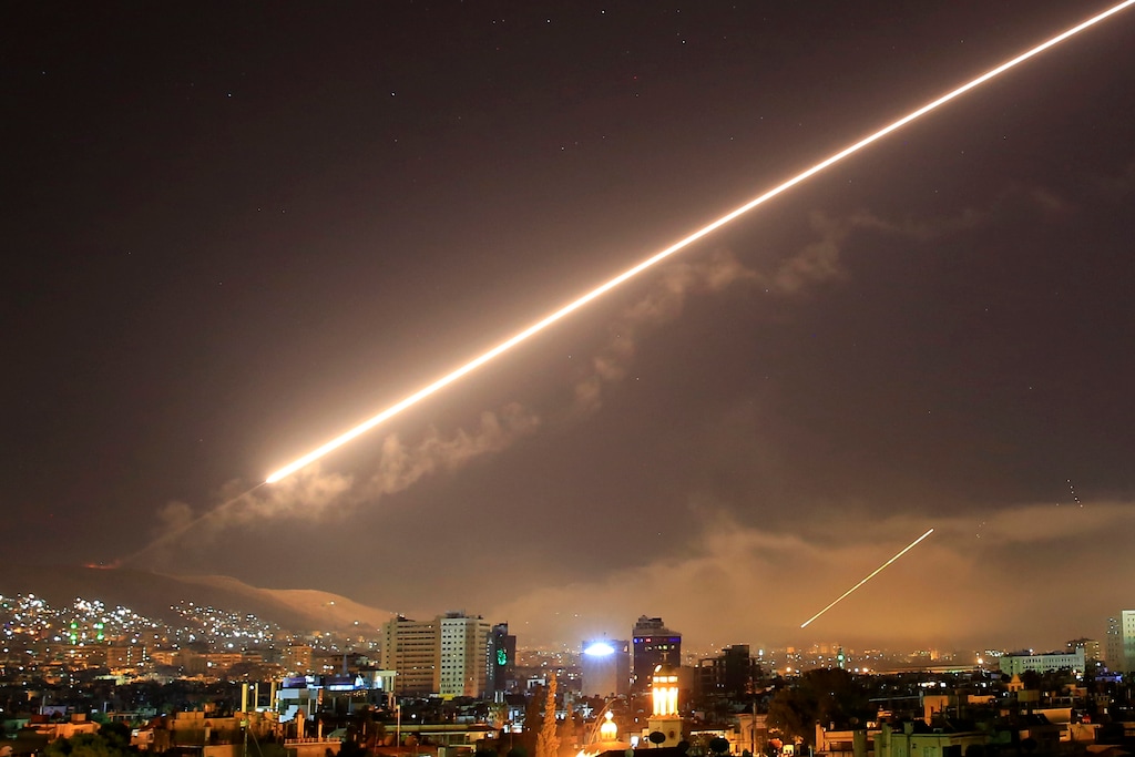 Damascus skies erupt with surface-to-air missile fire as the U.S. launches an attack on Syria targeting different parts of the capital, Damascus, early Saturday, April 14, 2018. Syria's capital has been rocked by loud explosions that lit up the sky with heavy smoke as U.S. President Donald Trump announced airstrikes in retaliation for the country's alleged use of chemical weapons. (AP Photo/Hassan Ammar)