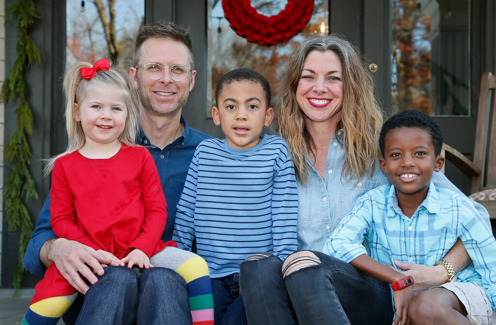 In this Sunday, Dec. 3, 2017, photo, Lance and Stephanie Schmidt pose for a photo with their children, from left, Stella, Theo and Solomon, at their home in Oklahoma City. The Schmidts have opted for a cost-sharing ministry this year after they realized their monthly insurance bill would have more than doubled to over $1,200 and stuck them with an $8,000 deductible for their family of five. (AP Photo/Sue Ogrocki)