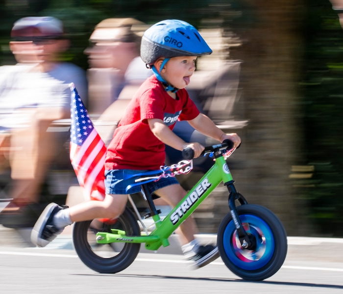 (Rick Egan | The Salt Lake Tribune) A young boy rides his Strider in the  Kids Bike Ride, in the Cherry Days Fourth of July Parade, in North Ogden, on Monday, July 4, 2022.
