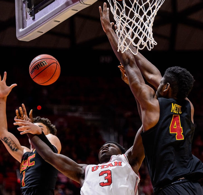 (Trent Nelson | The Salt Lake Tribune)  USC Trojans guard Jordan Usher (1) fouls Utah Utes forward Donnie Tillman (3) as the University of Utah hosts USC, NCAA basketball at the Huntsman Center in Salt Lake City, Saturday Feb. 24, 2018. USC Trojans forward Chimezie Metu (4) at right.