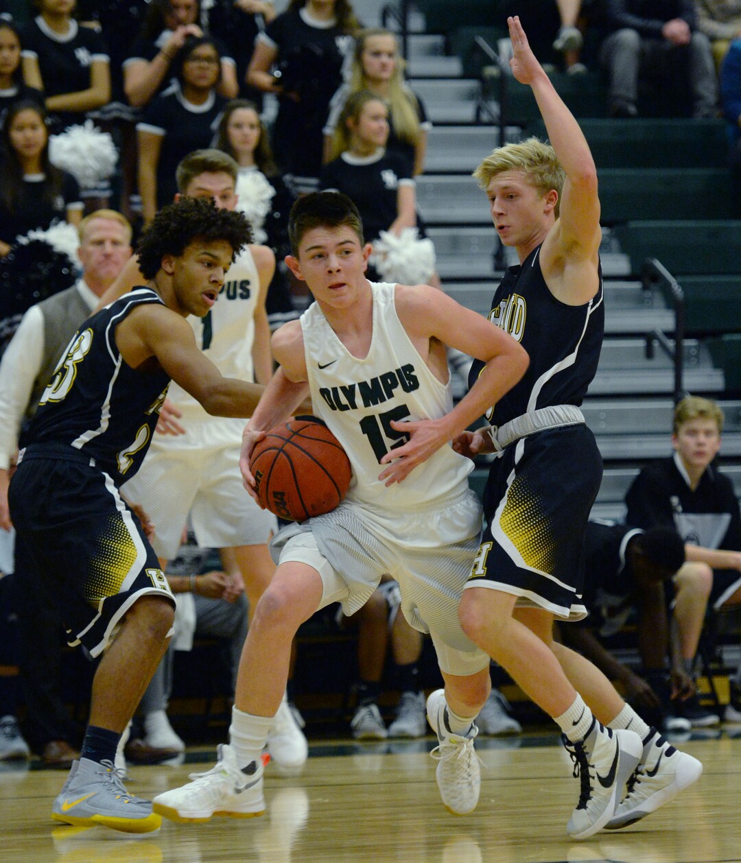 Steve Griffin / The Salt Lake TribuneOlympus guard Rylan Jones splits the Highland defense applied by Trayton Keyes , left, and Charlie Cochnour during game at Olympus High School in Salt Lake City Tuesday December 20, 2016. 