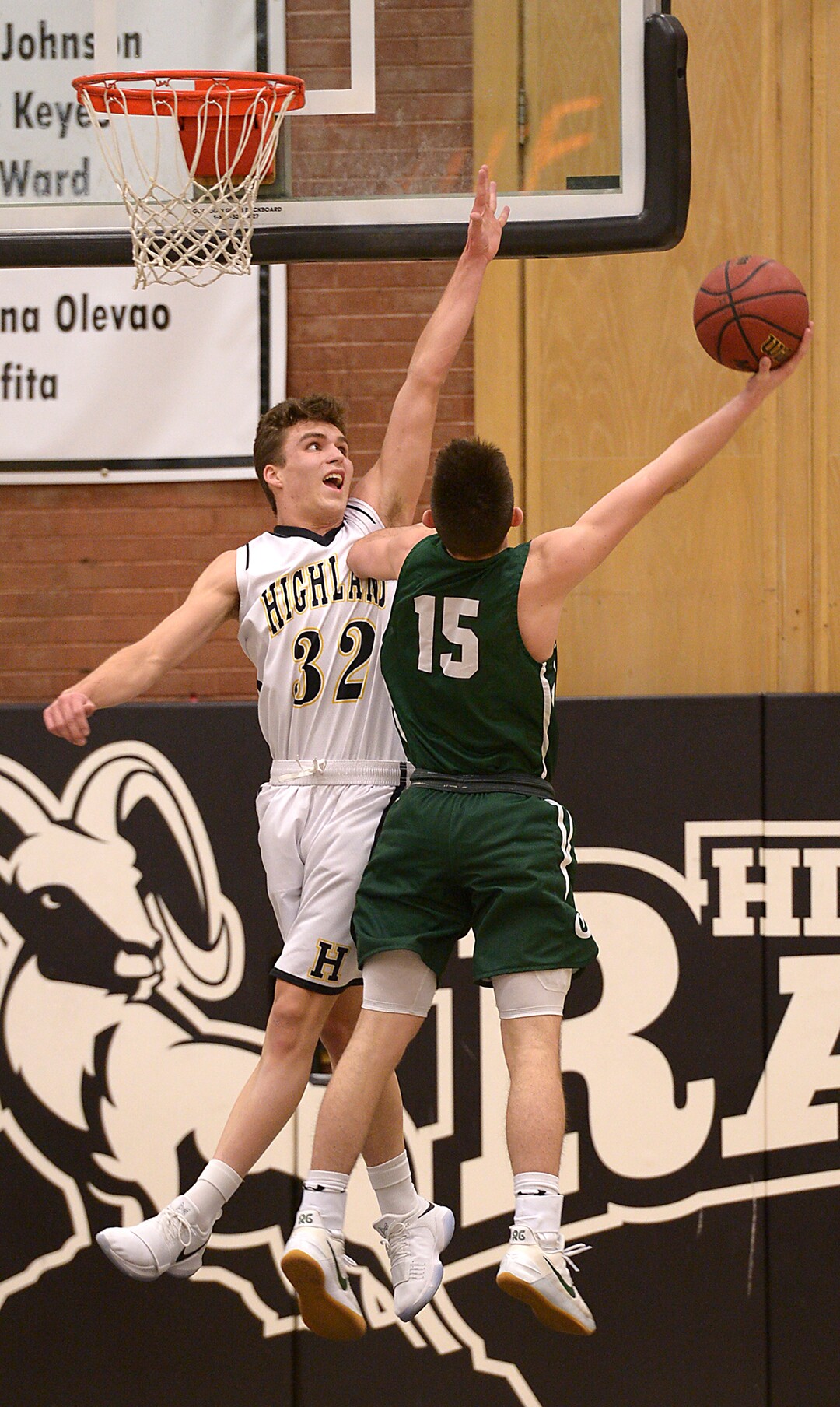 (Leah Hogsten  |  The Salt Lake Tribune) Olympus Rylan Jones tries to shoot around Olympus' Christian Rich.  High School defeated Highland High School 86-54 during their basketball game, Tuesday, February 6, 2018.