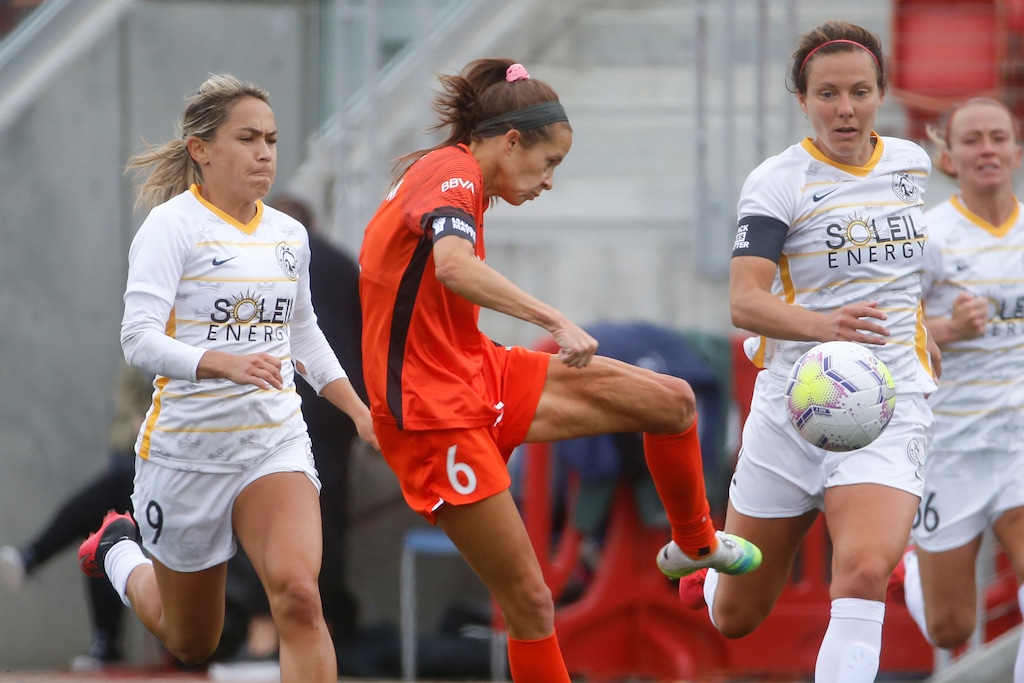 Houston Dash forward Shea Groom (6) takes a shot as Utah Royals FC midfielder Lo'eau LaBonta (9) defends during the first half of an NWSL Challenge Cup soccer match at Zions Bank Stadium Tuesday, June 30, 2020, in Herriman, Utah. (AP Photo/Rick Bowmer)