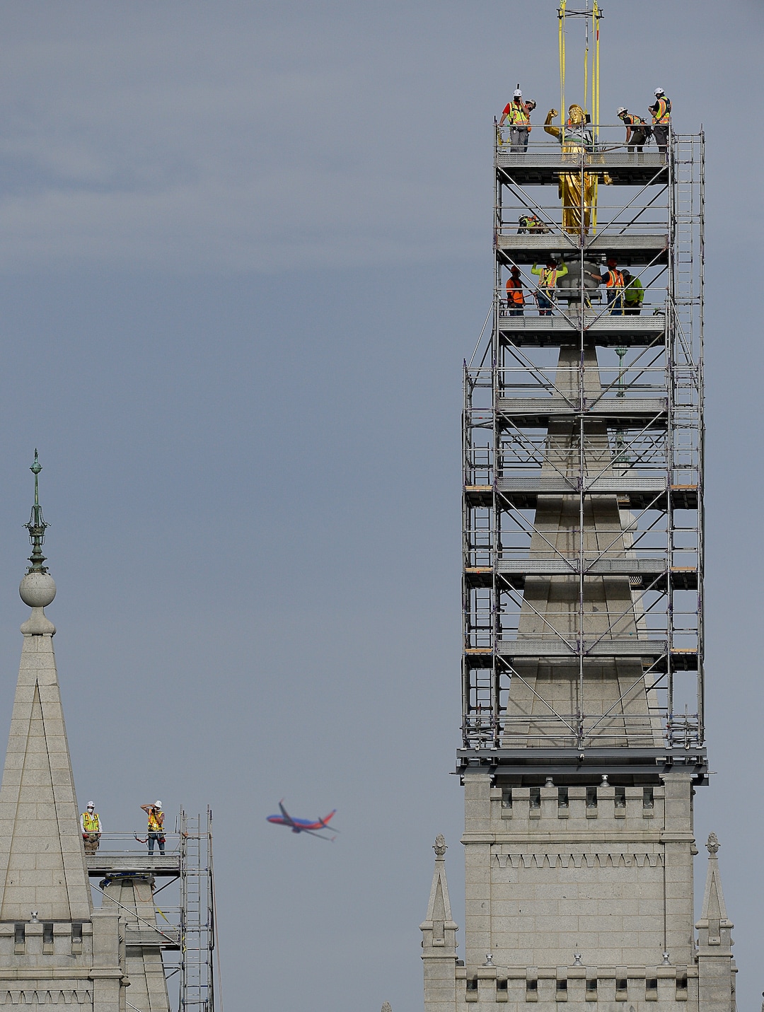 (Francisco Kjolseth  |  The Salt Lake Tribune) Crews work to remove the Angel Moroni statue atop the Salt Lake Temple of The Church of Jesus Christ of Latter-day Saints on Monday, May 18, 2020. The temple closed in December for seismic upgrades and sustained minor damager during the March 18, 2020, magnitude 5.7 earthquake when the trumpet held by the angel fell off and several smaller spire stones were displaced.
