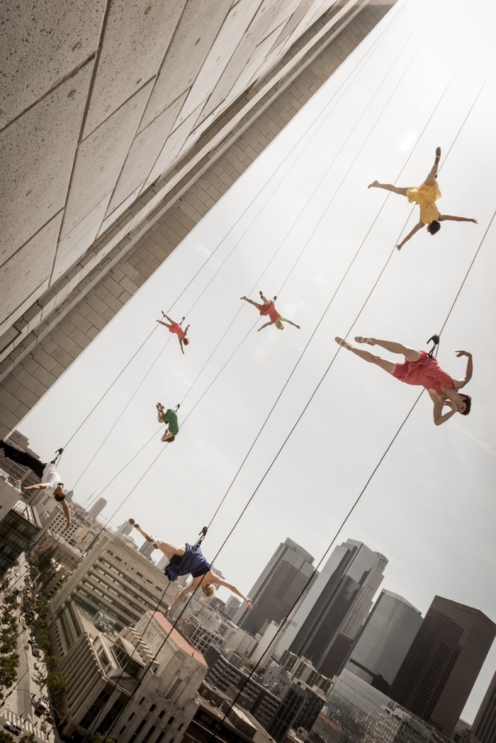(Photo courtesy of James Adams)  Oakland, Calif.-based “vertical dance” company BANDALOOP performs from Los Angeles’ City Hall building at the “La La Land” dedication day ceremony in April 2017. BANDALOOP will be appearing at the Utah Arts Festival June 21-24, and will perform twice daily (5:30 and 7 p.m.) on the six-story library glass wall above the reflecting pool.