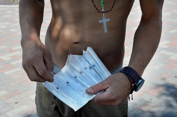 (Scott Sommerdorf | The Salt Lake Tribune) "Jonathan" holds some of the needles he was given at the needle exchange tent on 500 West & 300 South, August 3, 2017. He will use them to inject black tar heroin.