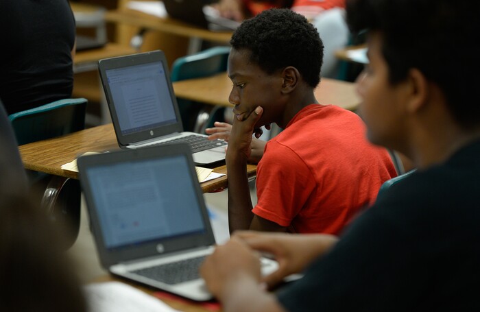 (Francisco Kjolseth  |  The Salt Lake Tribune)  David Harris concentrates on a writing skills assignment during English summer class at Hillcrest High School. Students who participate in the Husky Strong summer school program receive $5 a day to get a head start on the school year.