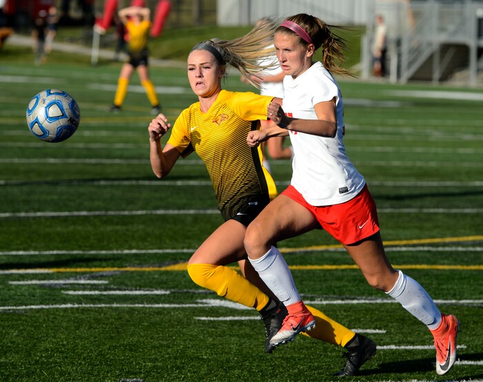(Steve Griffin | The Salt Lake Tribune) East's Hailey Povilus, right, and Maple Mountain's Anna Pickering chase down the ball during shootout against Maple Mountain during East's 5A semifinal girl's soccer match at Juan Diego High School in Draper Tuesday October 17, 2017.