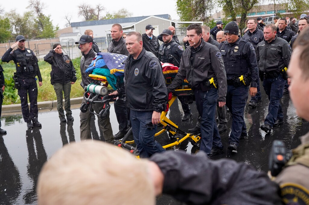 (Chris Samuels | The Salt Lake Tribune) Members of the law enforcement community form an honor line as the body of a Santaquin police officer is led into the Office of the Medical Examiner in Taylorsville, Sunday, May 5, 2024.
