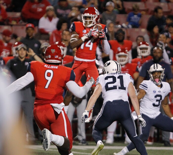 BYU's Talon Shumway, center, watches Fresno State's Jaron Bryant intercept a pass that was called back due to a penalty during the first half of an NCAA college football game in Fresno, Calif., Saturday, Nov. 4, 2017. (AP Photo/Gary Kazanjian)