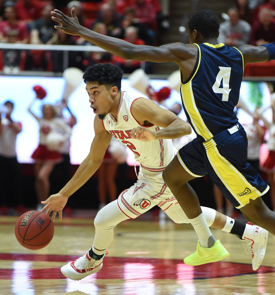 (Francisco Kjolseth  |  The Salt Lake Tribune) Utah Utes guard Sedrick Barefield (2) maneuvers oround Northern Arizona Lumberjacks guard Carlos Hines (4) in Men's Basketball at the Jon M Huntsman Center in Salt Lake City, Utah, on Friday, Dec. 21, 2018.