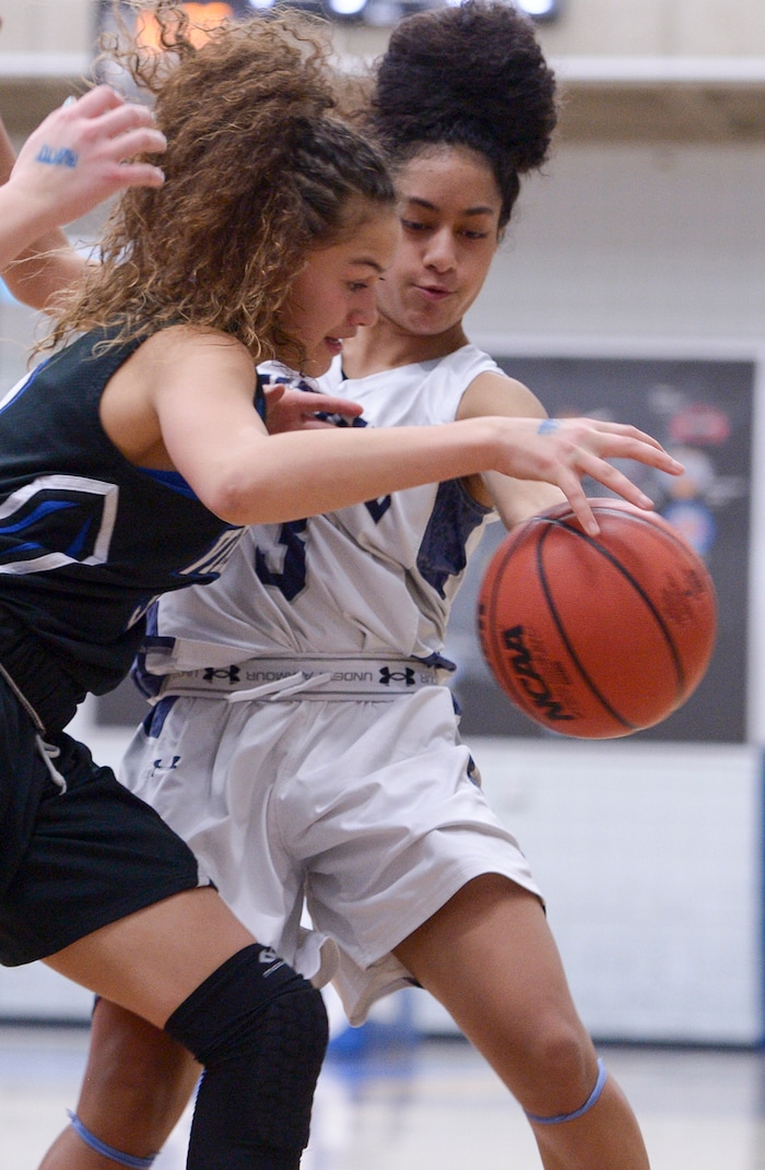 (Leah Hogsten  |  The Salt Lake Tribune)  Copper Hills' Eleyana Tafisi pressures Pleasant Grove's Eva-Simone Ongoongotau Copper Hills High School girls' basketball team defeated Pleasant Grove High School 66-25 during their Class 6A girls' basketball playoff opener at Salt Lake Community College Tuesday, Feb. 20, 2018. 