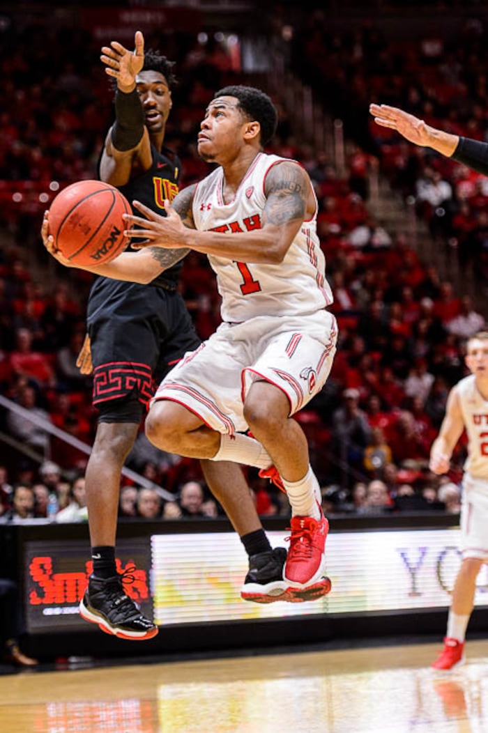 (Trent Nelson | The Salt Lake Tribune)  Utah Utes guard Justin Bibbins (1) drives with USC Trojans guard Jonah Mathews (2) defending as the University of Utah hosts USC, NCAA basketball at the Huntsman Center in Salt Lake City, Saturday Feb. 24, 2018.