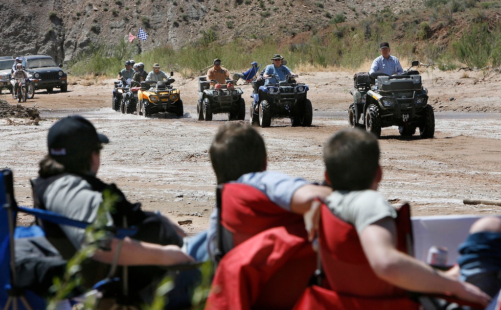 Scott Sommerdorf  |  The Salt Lake Tribune May 9, 2009


ATV'ers drive along the Paria River as counter-protestors at the "Picnic With a Purpose" watch in the foreground during a 2009 ride protesting BLM road closures in Grand Staircase-Escalante National Monument. The 22-mile route along the Paria, which is closed to motorized use, is among 15 "bellwether" routes in Kane County that a federal judge plans to tour this month as he prepares for a trial that could resolve Utah state officials' disputed claims to 14,000 routes across public lands.