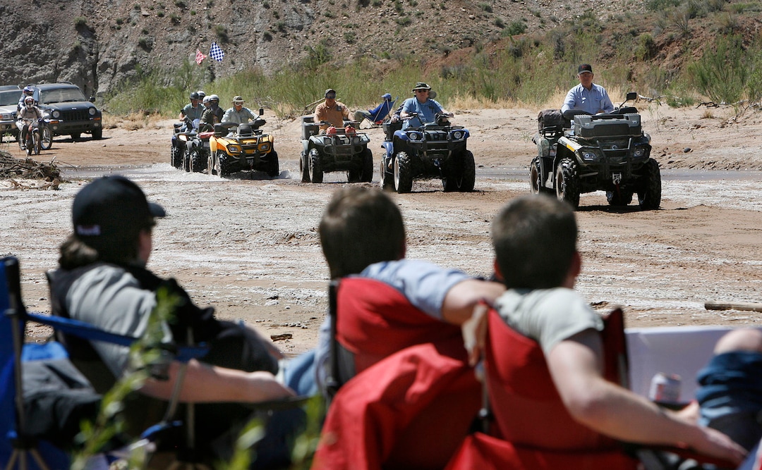 Scott Sommerdorf  |  The Salt Lake TribuneATV'ers drive along the Paria Riverbed as anti-protest protestors at the "Picnic With a Purpose" watch in the foreground. ATV and off-road vehicle riders numbering just over 100 protested BLM road closures in Grand Staircase-Escalante National Monument and will gather to force their way onto federal land. They will be criss-crossing the Paria River. Saturday, 5/9/09.