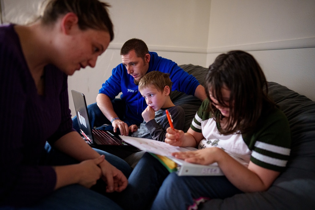 (Trent Nelson | The Salt Lake Tribune) Megan and Kaden Mattinson work with their homeschooled children Colten and Aspen in Springville on Thursday, May 9, 2024. Rather than a flat $8,000 scholarship for everyone, Utah’s homeschoolers could see less funding than those attending private schools.