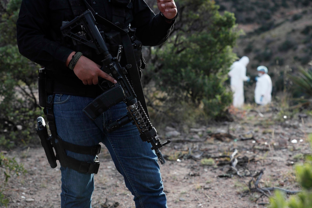 (Marco Ugarte |AP) Under heavy security forensic investigators walk the site where nine U.S. citizens, three women and six children related to the extended LeBaron family, were slaughtered when cartel gunmen ambushed three SUVs along a dirt road near Bavispe, at the Sonora-Chihuahua border, Mexico, Wednesday, Nov 6, 2019. Three women and six of their children, related to the extended LeBaron family, were gunned down in an attack while traveling along Mexico's Chihuahua and Sonora state border on Monday.