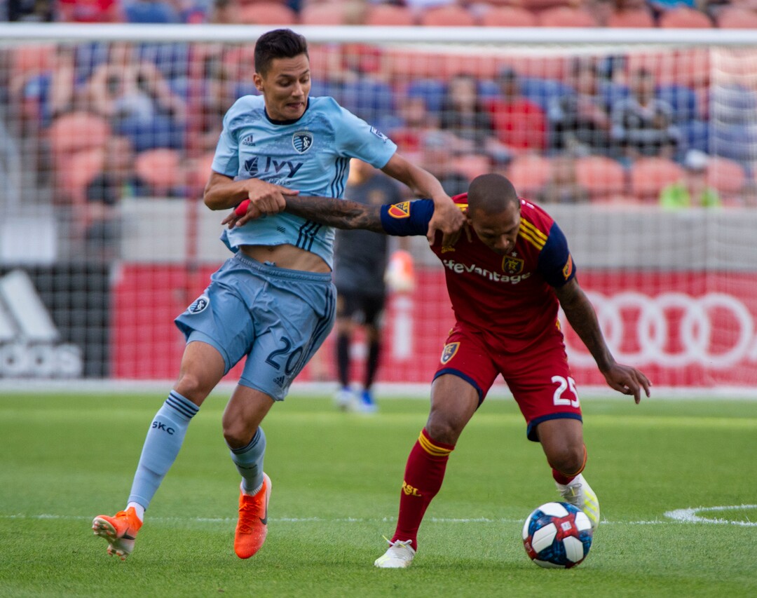 (Rick Egan  |  The Salt Lake Tribune)  Real Salt Lake midfielder Sebastian Saucedo (23) collides with Sporting Kansas City forward Daniel Salloi (20), in MLS soccer action between Real Salt Lake and Sporting Kansas City, in Sandy, Saturday, June 29, 2019.