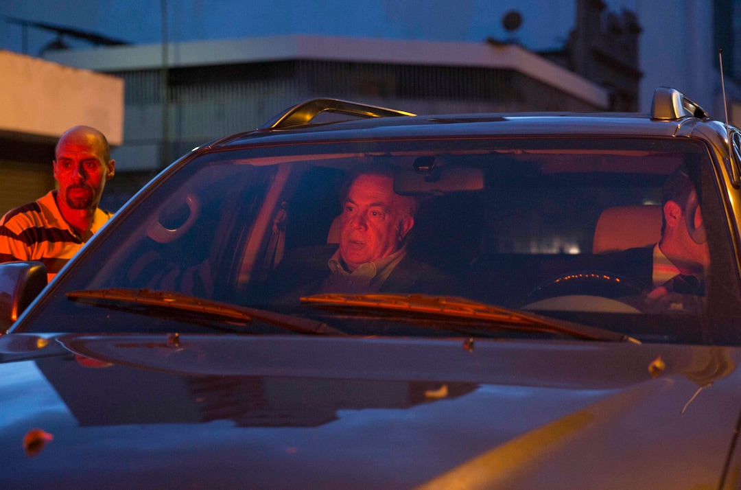 In this Nov. 8, 2017 photo, wealthy businessman Wilmer Ruperti, center, in car, leaves a courthouse in Caracas, Venezuela. Ruperti, a key ally of Venezuela’s government, is paying the legal bills of Joshua Holt, an American who claims to have been wrongly imprisoned in Venezuela, a new wrinkle in a case that has further strained relations between Washington and Caracas. (AP Photo/Ariana Cubillos)