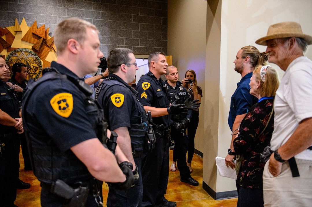 (Trent Nelson  |  The Salt Lake Tribune)  
Ethan Peterson argues with police who have removed him from a meeting of an inland port satellite working group held at a police precinct in Salt Lake City on Wednesday, Aug. 14, 2019. With Peterson are Jill Merritt and Alan Ernstsen. The meeting was quickly canceled soon after it began.