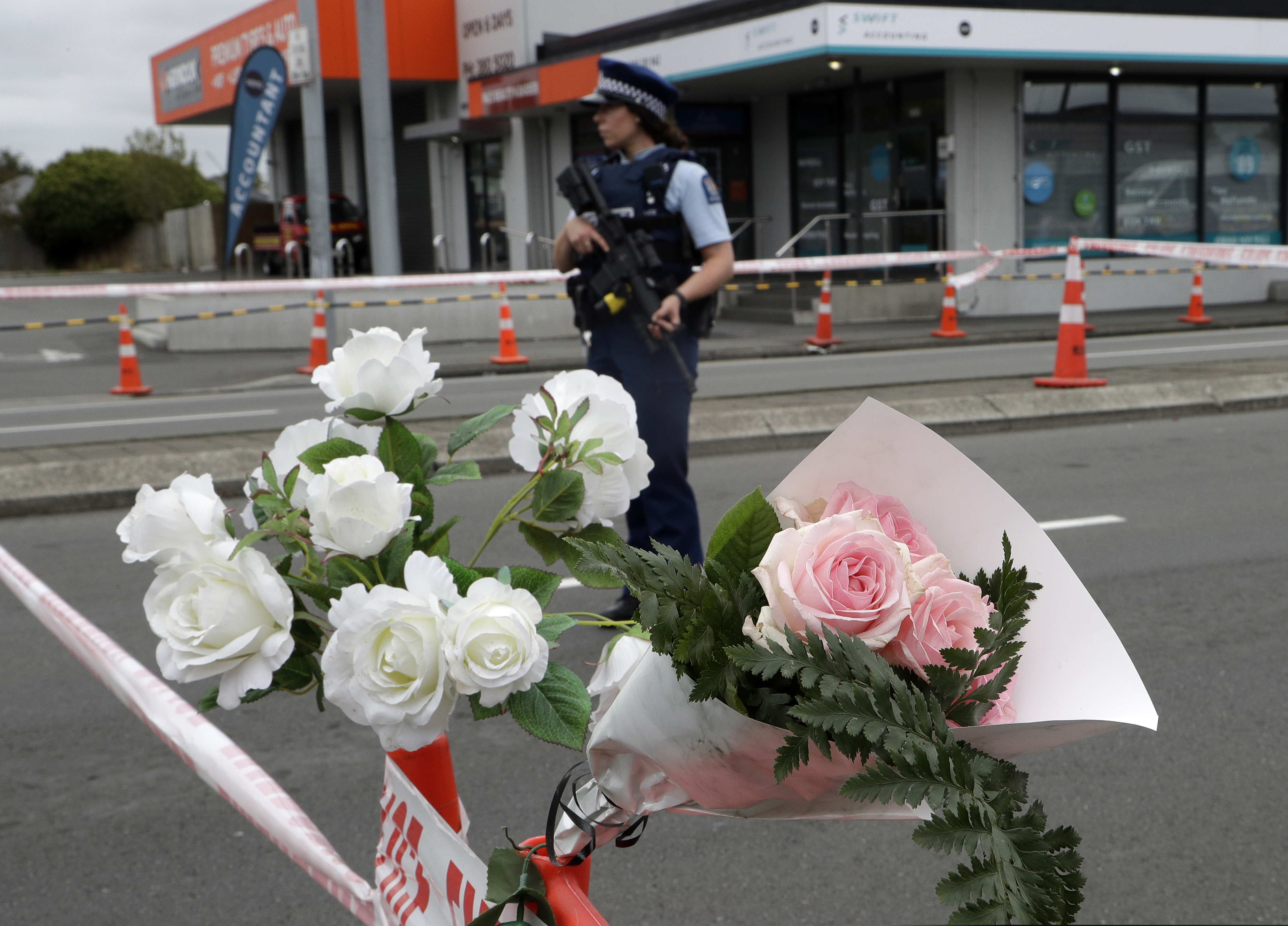 A police officer stands at a police cordon at an intersection near the Linwood Mosque in Christchurch, New Zealand, Sunday, March 17, 2019. The live-streamed attack by an immigrant-hating white nationalist killed dozens of people as they gathered for weekly prayers in Christchurch on Friday, March 17. (AP Photo/Mark Baker)