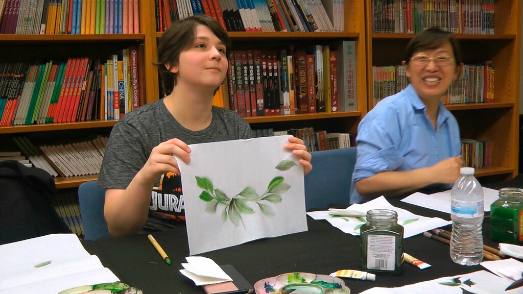 (Matthew Pennington | AP file photo) This May 2, 2018, file photo shows undergraduate student Moe Lewis, left, displaying her watercolor painting of peony leaves at a traditional Chinese painting class at the Confucius Institute at George Mason University in Fairfax, Va. U.S. lawmakers — and now state legislatures, including Utah's — are pushing for tighter regulation or even closure of the more than 100 Chinese Confucius Institutes set up on campuses across America.