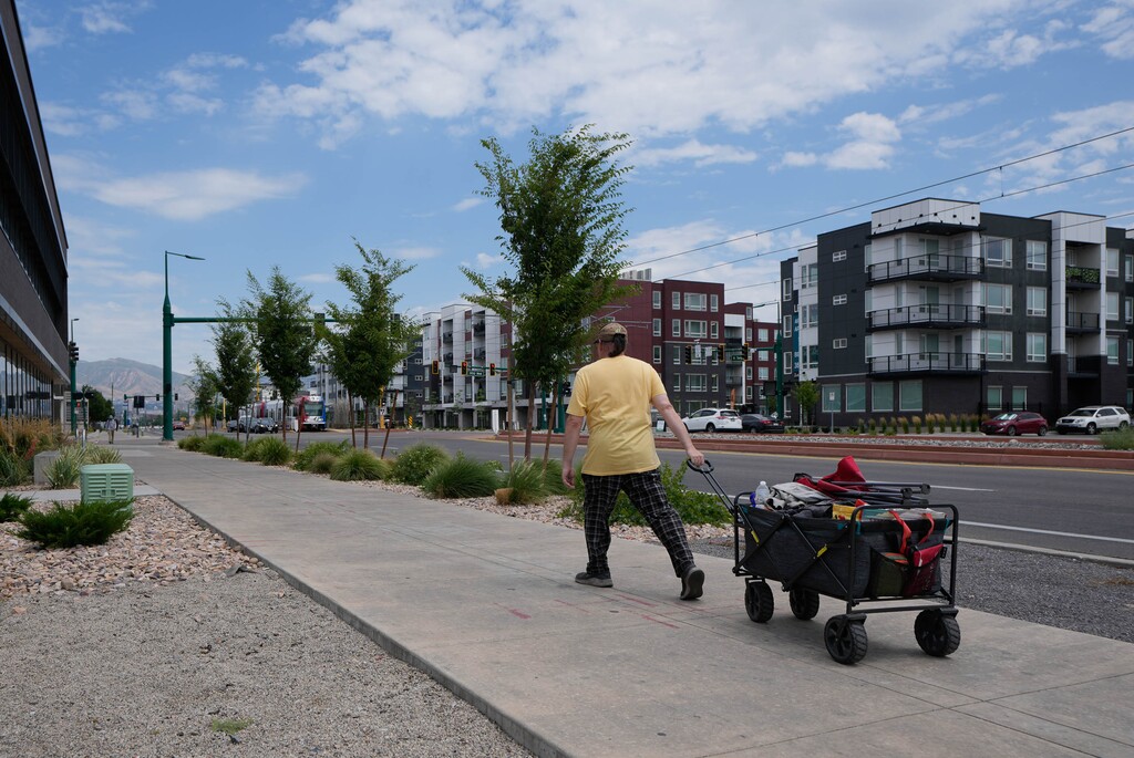 (Francisco Kjolseth | The Salt Lake Tribune) A man pulls his belongings on Friday, July 18, 2025. Utah leaders are contemplating big changes to the state's homeless services system.