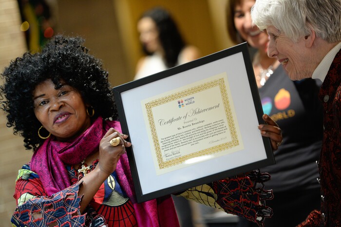(Francisco Kjolseth  |  The Salt Lake Tribune)  Rosette Rwaminigiho who fled the Congo with her children after losing her husband, sister and business to war, proudly holds a certificate of achievement during Women of the World's 8th annual award ceremony at the Salt Lake County building in Salt Lake City on Saturday, Dec. 8, 2018, as a celebration of successes including educational, service, and employment milestones by refugee women.