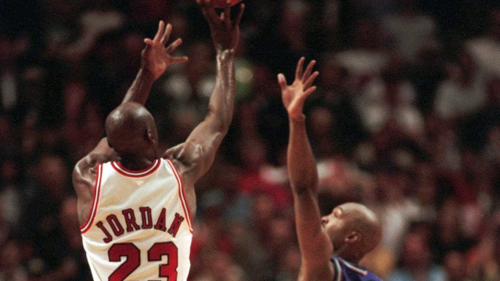 The Chicago Bulls' Michael Jordan puts up the game-winning shot over Utah Jazz forward Bryon Russell, right, to win Game 1 of the  NBA Finals 84-82 Sunday, June 1, 1997, in Chicago.  (AP Photo/Fred Jewell )