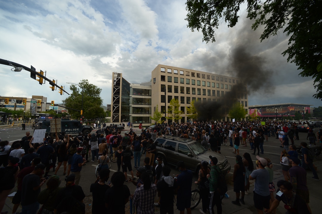 (Leah Hogsten  |  The Salt Lake Tribune)   Marchers block a street in downtown Salt Lake City after setting a police car on fire on  May 30, 2020.