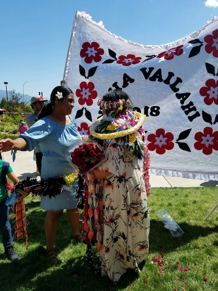 (Courtesy of Claustina Mahon-Reynolds) High school students in Salt Lake City School District wear bundles of leis after graduation this year. The flower necklaces were banned from the floor during the ceremonies at the Huntsman Center. Pacific Islander students, when allowed, typically wear one or two fresh leis during their graduation to honor their heritage. Relatives then pile more on after the ceremony, in celebration.
