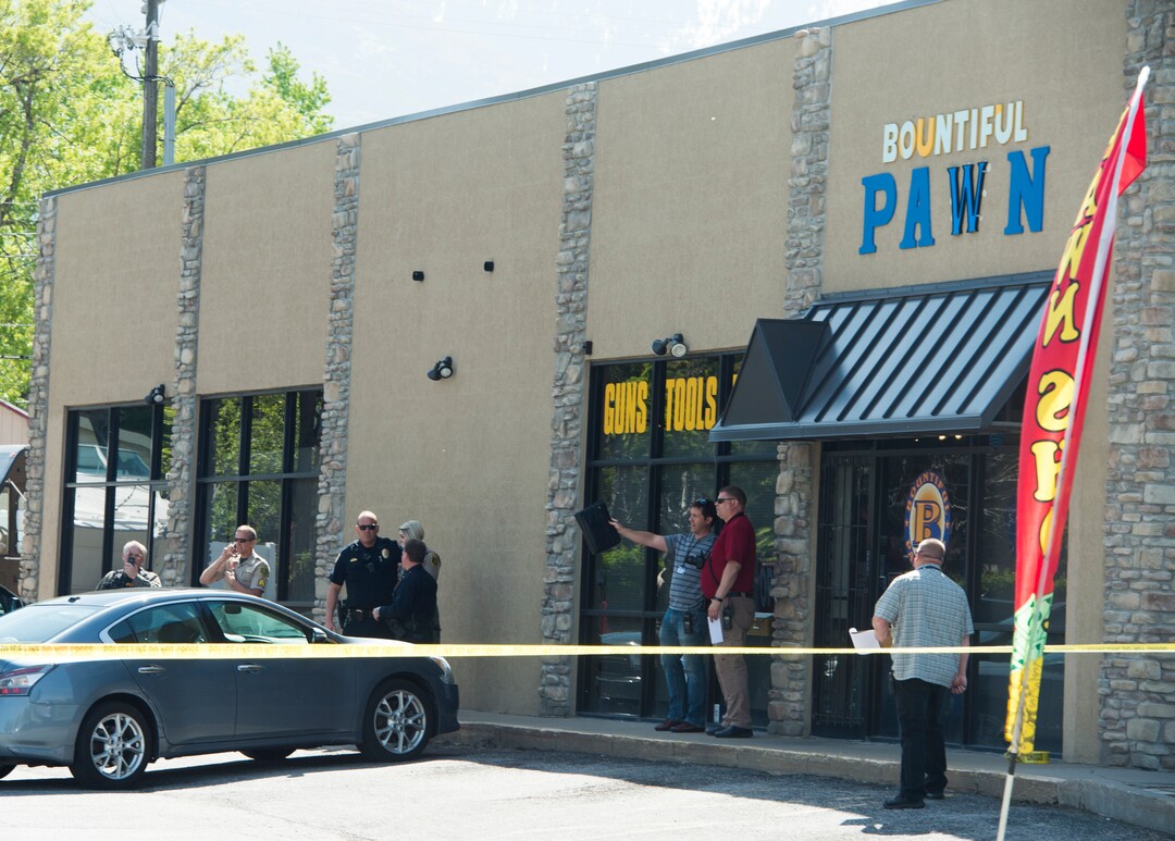(Rick Egan  |  The Salt Lake Tribune)   Bountiful police investigate after they say a store clerk shot an armed robbery suspect at Bountiful Pawn and Sales on Thursday, May 3, 2018. Police are looking for a second suspect in the attempted armed robbery.