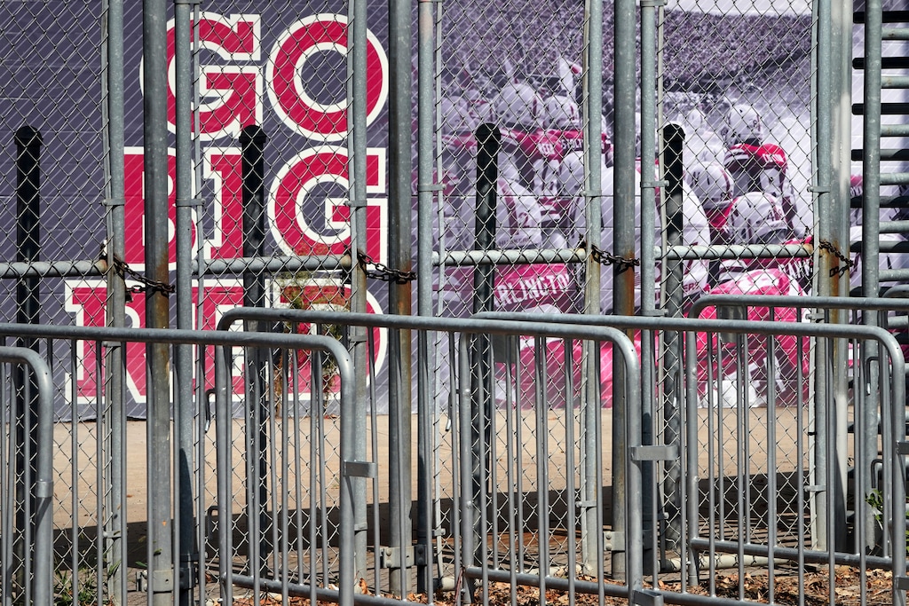 (Nati Harnik | AP) A mural showing Nebraska football players and Go Big Red lettering are seen past locked gates at Memorial Stadium in Lincoln, Neb., Tuesday, Sept. 15, 2020.