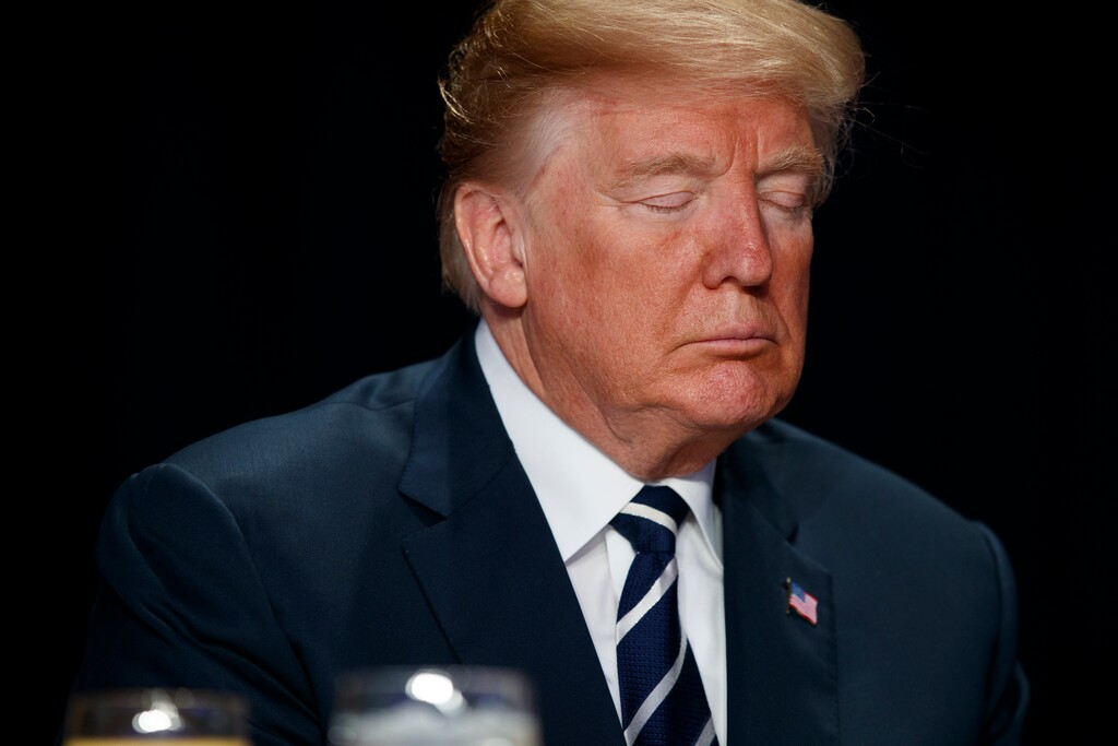 (AP Photo/Evan Vucci) President Donald Trump prays during the National Prayer Breakfast, Thursday, Feb. 8, 2018, in Washington.