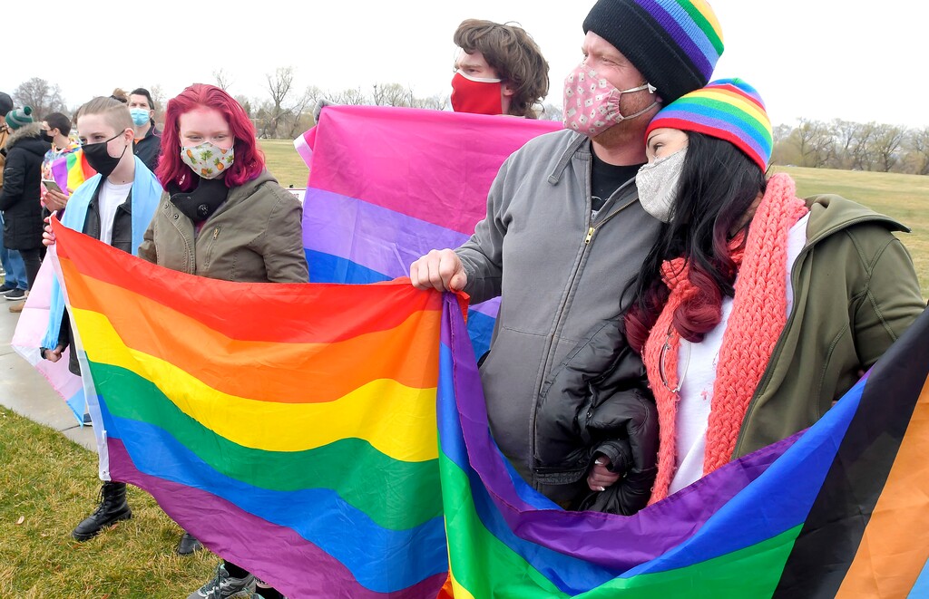 (Eli Lucero | Herald Journal) Members of the Olsen and Thorell family hold pride flags  during a rally in support of LGBTQ students on Wednesday, April 14, 2021, at Ridgeline High School in Millville. 