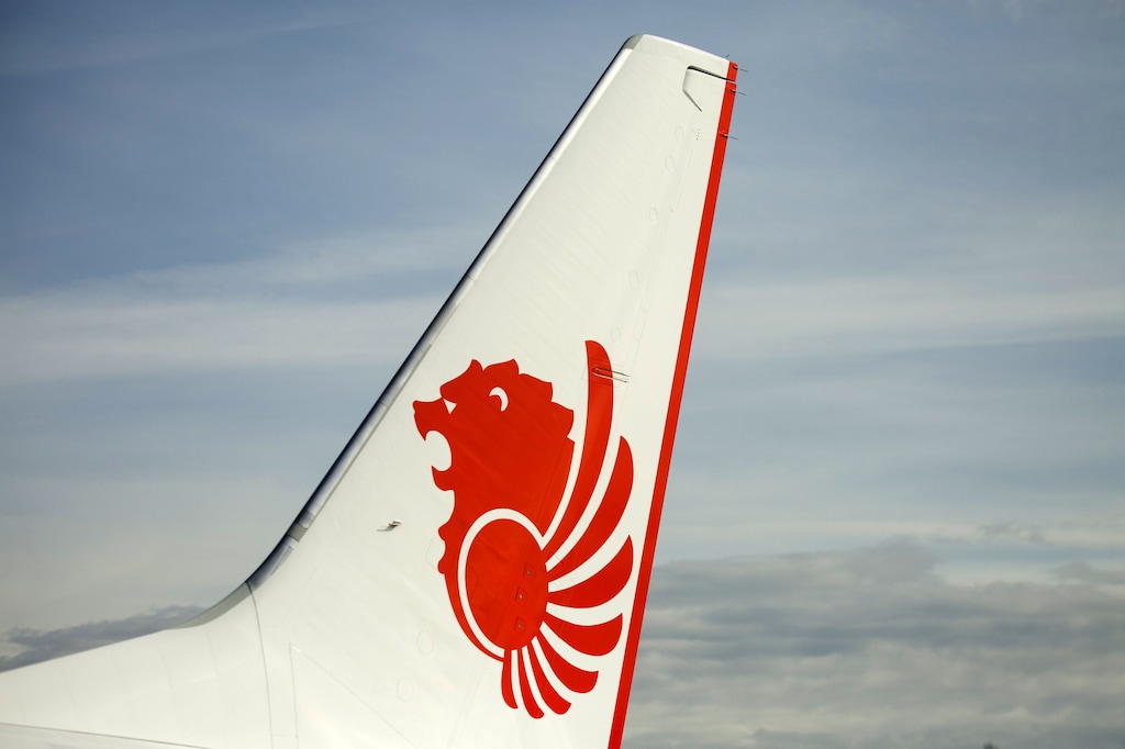 (David Ryder | Bloomberg) Lion Air Group livery is displayed on the tail fin of a Boeing 737 Max 9 aircraft during a ceremony at the Boeing delivery center in Seattle on March 21, 2018.